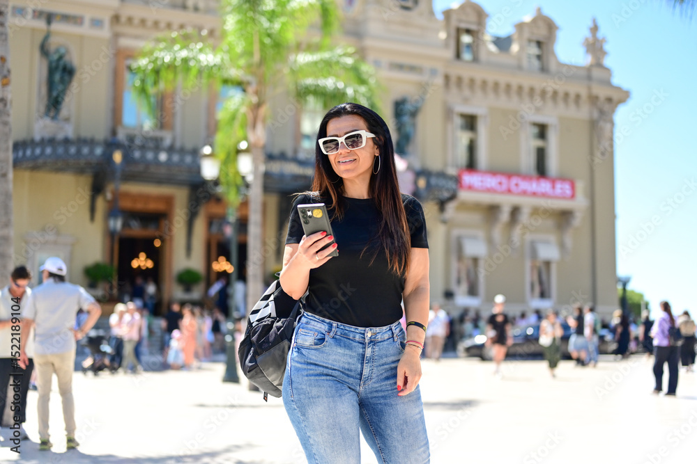 Fototapeta premium Portrait of happy smiling woman at Monaco . Casual portrait outdoors, tourist in Monte Carlo Brunette woman near the Casino of Monte Carlo