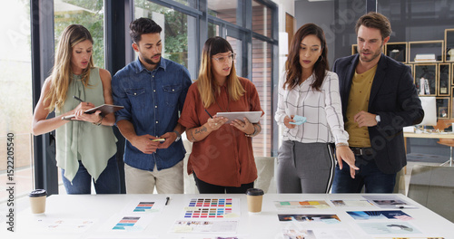 Group, creative business people and discussion in meeting for brand strategist with tablet. Team, manager and collaboration in startup office for planning, proposal and choice for ad campaign design