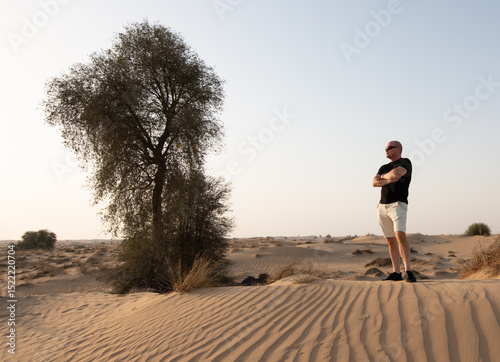 Middle aged man enjoying the desert sunset in Dubai