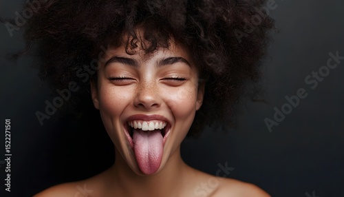 Close-up portrait of a woman with her tongue out.
