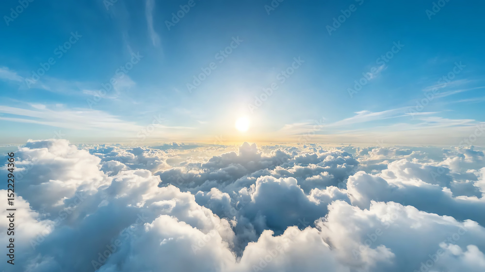Fototapeta premium A stunning view of a bright sun rising above fluffy clouds in a clear blue sky, evoking a sense of peace and tranquility.