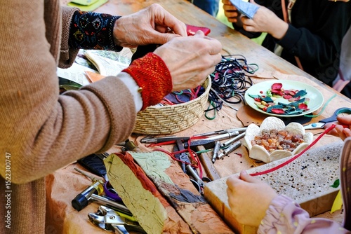 Craft workshop with tools and textures. Making crafts with leather ribbons. Selective focus.