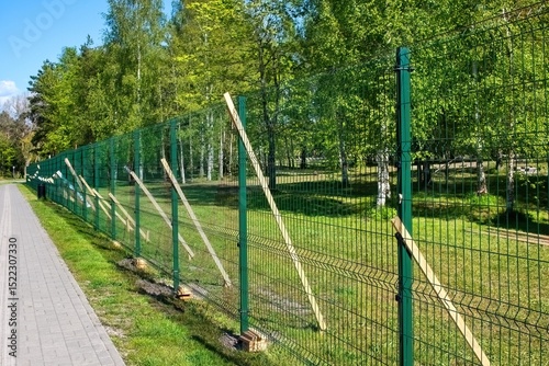 Construction of a metal fence along the park.