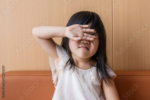 A sleepy Chinese girl on the sofa