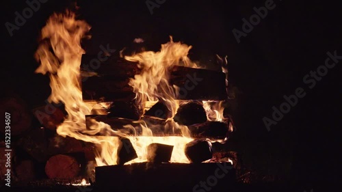 Big Night Bonfire Burns in the Dark Flaming Campfire at Nighttime. Fire Pit Outdoors. Video with sound.