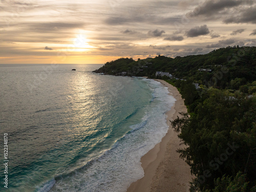 Wallpaper Mural The sun sets over a serene coastline with gentle waves, reflecting golden hues. Anse Intendance. Seychelles, Mahe. Torontodigital.ca