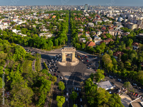 Aerial Bucharest. Arch of Triumph, Kiseleff boulevard and Herastrau Park in an aerial photo taken in the north part of Bucharest, Romania, during a summer day. Bucharest from above.