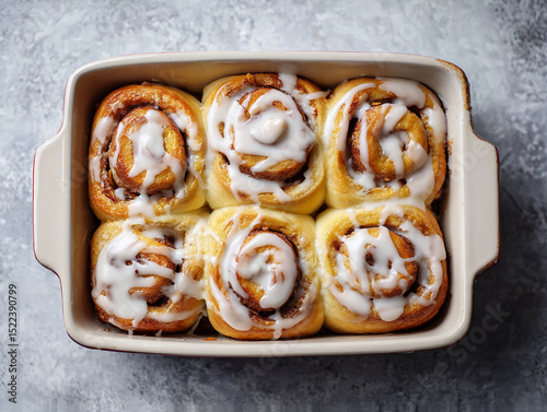 Baked cinnamon rolls with icing, top-down view 