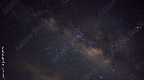 The pitch-black night sky, with the visible Milky Way at its center, presents an eerie and mysterious atmosphere, perfect for space-travel or cosmic-event imagining.