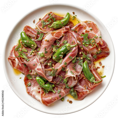 Sliced raw ham with green chili peppers and fresh herbs