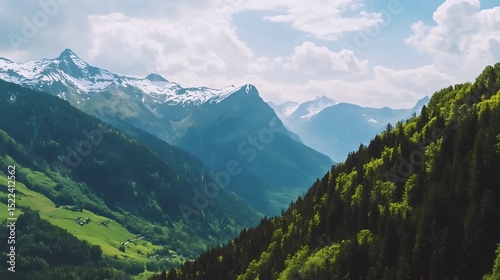 Alpine valley landscape with snow capped mountains