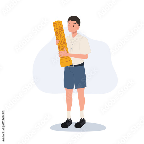 thai schoolboy holding large wax candle for buddhist holiday celebration in thailand cultural festival and asian tradition.