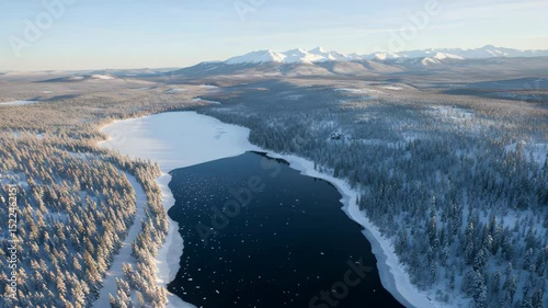 Wallpaper Mural Winter Wonderland Aerial View of Dark Lake Surrounded by Snow Covered Trees and Distant Mountains Under Clear Sky Torontodigital.ca