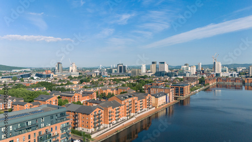 Fototapeta Naklejka Na Ścianę i Meble -  Aerial drone photo of Bute East Dock and the Atlantic Wharf neighbourhood in Cardiff, Wales, with a panoramic view of the city centre in the background. 