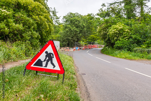 Country Road Stone Bridge Under Repair with Warning Sign Lined with Trees