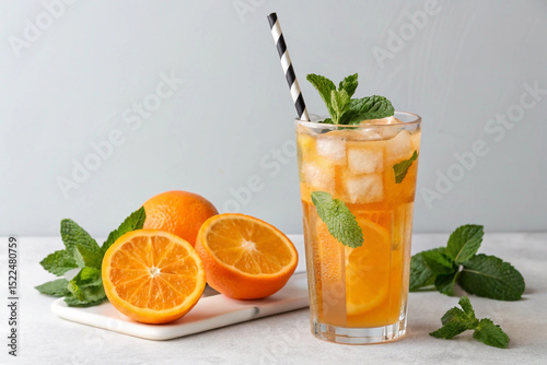 A tall, clear glass filled with a refreshing orange drink