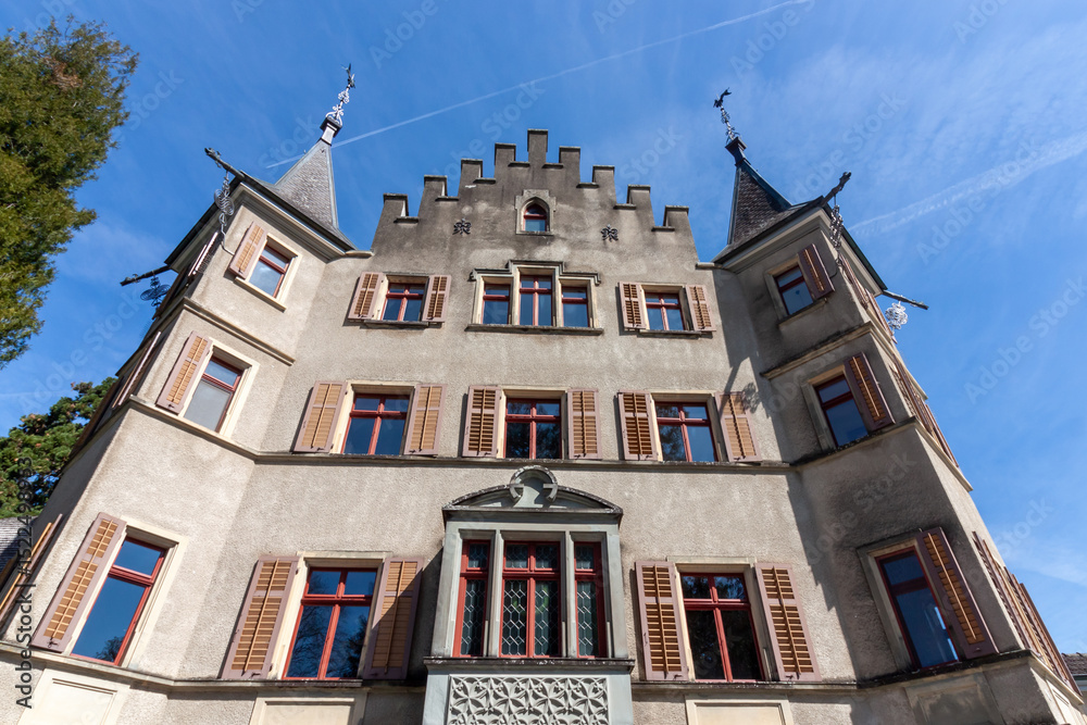 Fototapeta premium A picturesque view of Seeburg Castle in Kreuzlingen, Switzerland, standing majestically on the tranquil shores of Lake Constance