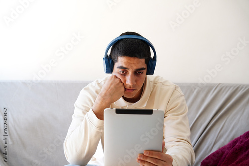 Young Arab man using a tablet at home