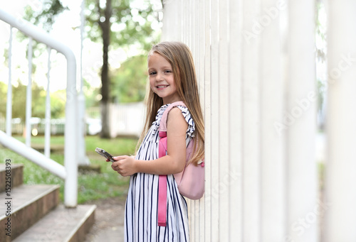 Free Download Cute school girl with backpack using smartphone - GFXLoad