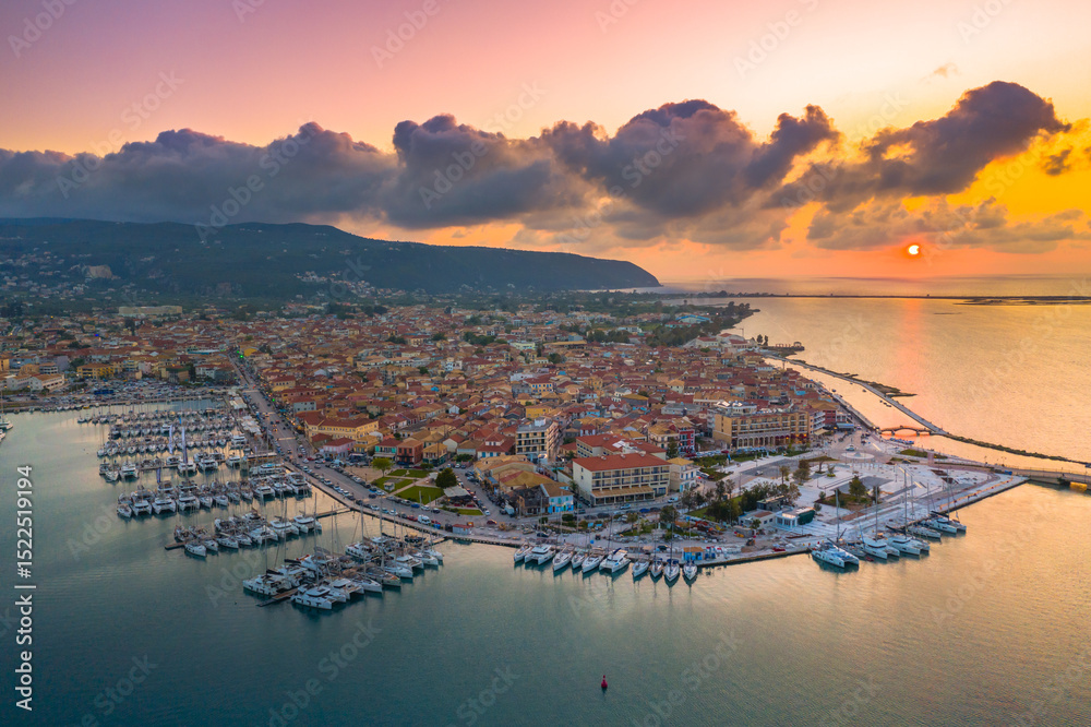 Fototapeta premium Lefkas (Lefkada) town, amazing view at the small marina for the fishing boats with the nice wooden bridge and promenade, Ionian island, Greece