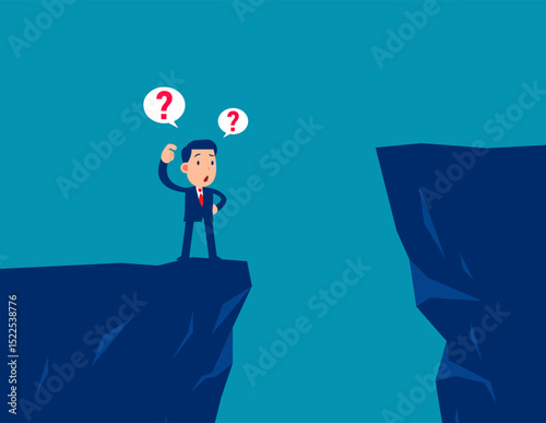 Confusion. Businessman standing on the edge of ravine thinking before making a decision