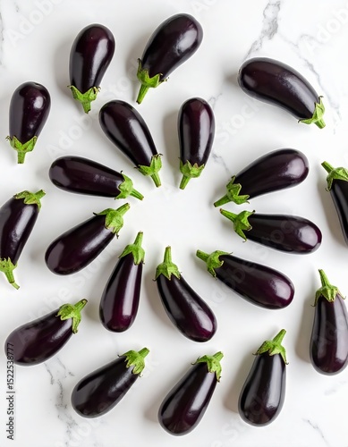 Freshly harvested eggplants arranged in a circular pattern on a marble surface