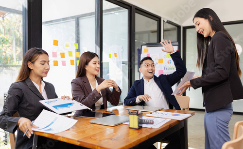 Group of Asian business working plan analysis project brainstorm in modern office, Asian businesspeople team working together, Business startup and company strategy planning concept.
