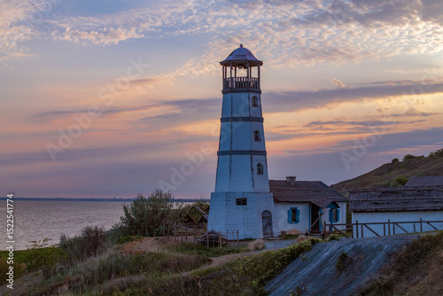 Old lighthouse on the shore of the Azov sea on a sunset. Merzhanovo. Rostov region, Russia