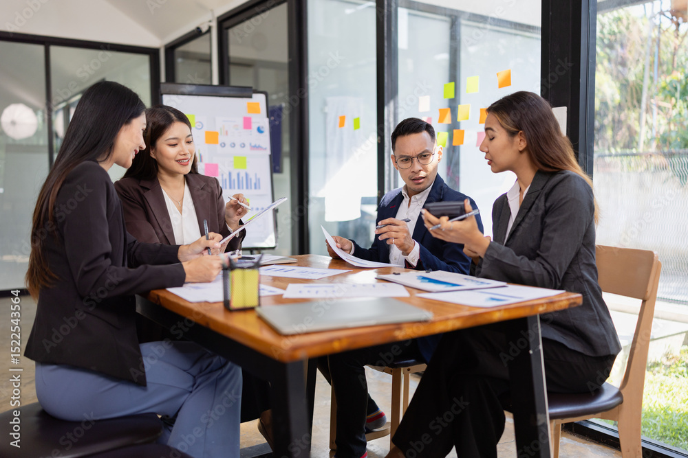 Fototapeta premium Group of Asian business working plan analysis project brainstorm in modern office, Asian businesspeople team working together, Business startup and company strategy planning concept. 