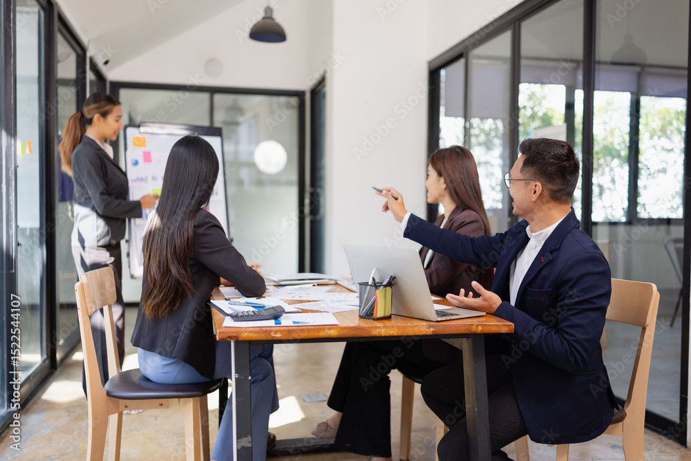 Fototapeta premium Group of Asian business working with analysis project brainstorm in modern office, Asian businesspeople team working together, Business startup and company strategy planning concept.