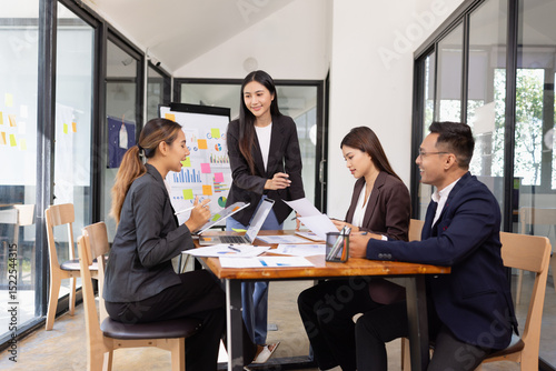 Group of Asian business working with analysis project brainstorm in modern office, Asian businesspeople team working together, Business startup and company strategy planning concept.