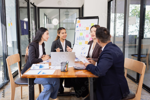Group of Asian business working with analysis project brainstorm in modern office, Asian businesspeople team working together, Business startup and company strategy planning concept.