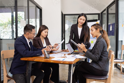 Group of Asian business working with analysis project brainstorm in modern office, Asian businesspeople team working together, Business startup and company strategy planning concept.