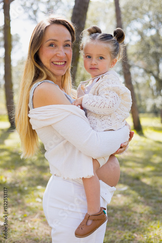 Pregnant woman enjoying outdoor time with daughter