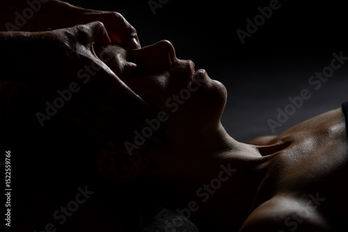 facial massage with dark background