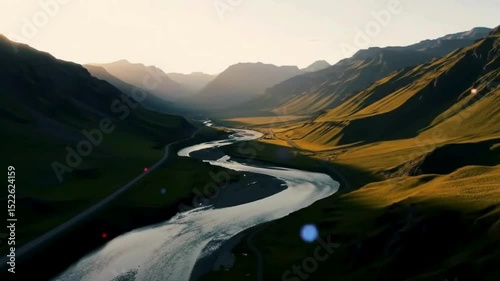 Scenic mountain landscape with a lake, clouds, and green valleys