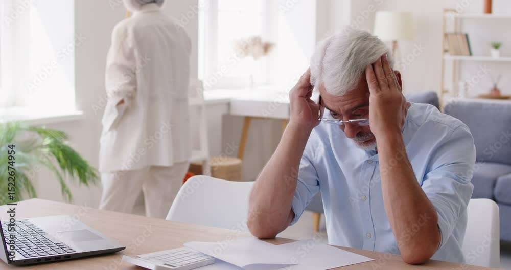 Serious frustrated senior man stress, problem, calculating payment online, watching laptop screen, feeling worry, old people elderly family home accounting, analyze bad financial account, poor budget
