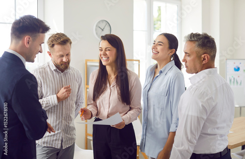Team of office people conducting a group meeting, laughing and communicating. This business environment fosters teamwork, connection, and effective collaboration for achieving goals.