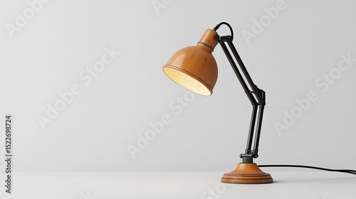 A gently curved, amber-hued desk lamp with a black adjustable arm sits on a minimalist white surface, softly illuminating the scene.  Its warm light casts a subtle glow