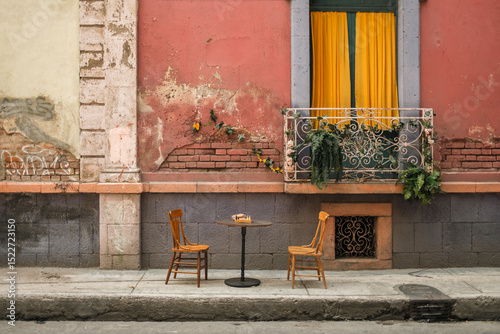 Quaint Cafe Table and Chairs on a Historic Street in Mexico