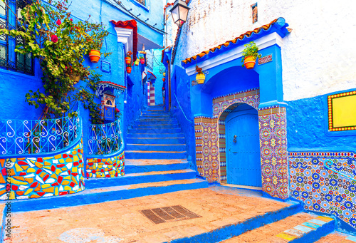 Chefchaouen, Morocco: Blue narow stairs with colourful walls and flowerpots into old walled city, or medina, North Africa