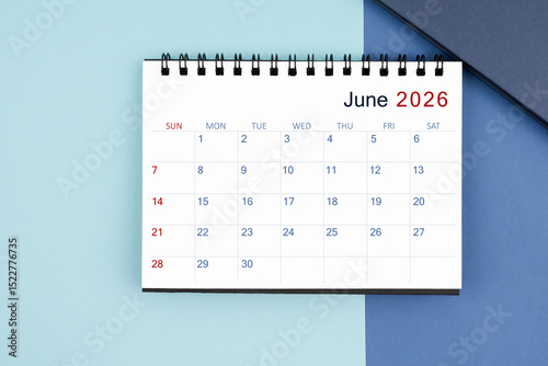 June 2026 monthly desk calendar for 2025 year on blue background.