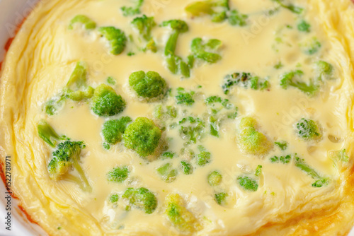 Broccoli egg omelette in a plate on the table. Diet nutrition. Closeup