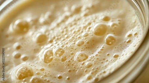 Bubbling sourdough starter in a glass container showcasing fermentation process