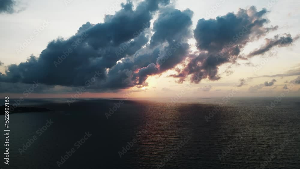 Aerial view of epic dark clouds flying into camera, scenic sunrise sun at sea. Cinematic Timelapse shot of beautiful sunrise at sea, shot on drone. Starting new day at sea, cinematic aerial video