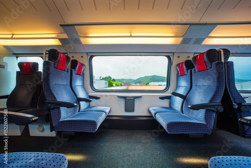 Wallpaper Mural Blue empty opposing, first class seats in a moving train. Large window, daytime, summer, no people. Torontodigital.ca