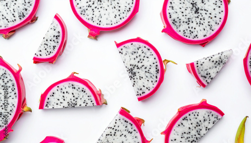the image features an arrangement of sliced tropical fruit against a plain backdrop. sections of the fruit, cut into various sizes and shapes, are spread throughout the scene