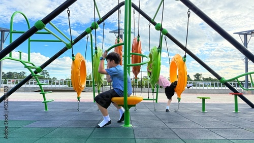 Kid, hanging and monkey bars play outdoors playground, climbing or games with exercise of motor development. Outdoors, development and portrait of kids for playing, freedom and summer adventure with s