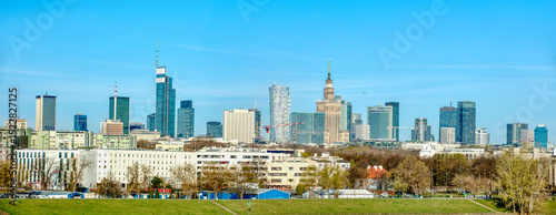 Panoramic view of Warsaw's skyline with modern and historic buildings.