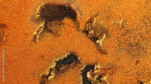 Macro shot of rough golden glitter texture with organic cracked patterns, intense abstract detail